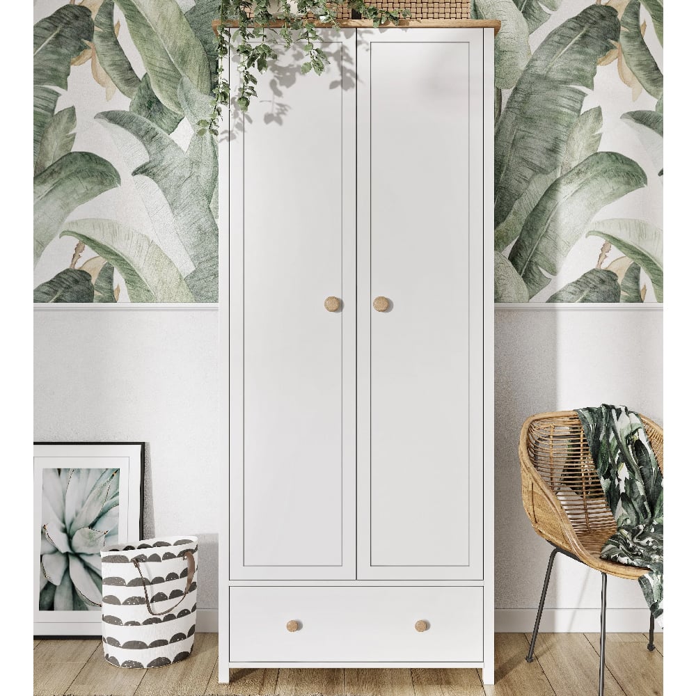 White 2 door wardrobe with wooden handles and a drawer, against leafy wallpaper.