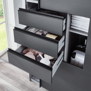 Three partially open black drawers of the CHOICEWARDROBE Sogo 2 Door Sliding Wardrobe reveal organized compartments for clothing and accessories. This modern oak & black unit features drawers, shelves, and hanging rails near a window with a grass view.