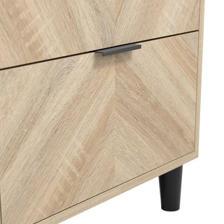 Close-up of the CHOICEWARDROBE Stockholm 1 Door Wooden Wardrobe in a 50cm natural oak finish with a modern chevron design, featuring a black handle, drawer, and black cylindrical leg at the bottom right.