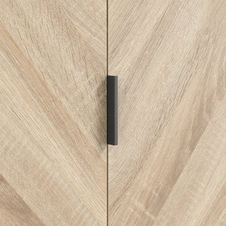 Close-up of the CHOICEWARDROBE Stockholm 100cm Chevron-Design Wardrobe in Sonoma Oak, showing its black vertical handle centered where the two doors meet. The diagonal chevron wood grain adds a modern, minimalist touch to the Scandinavian-inspired design.