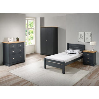 A bedroom with grey and oak effect furniture, including a bed, nightstand, dresser, and a CHOICEWARDROBE Talox 100cm Grey Painted Wooden 2 Door Wardrobe with Oak Top. Light walls, wood flooring, large window, and two framed prints complete the room.