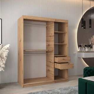 The CHOICEWARDROBE Tavira 150 cm Artisan Oak Sliding Door Wardrobe, featuring a modern 2-door design and natural wood finish, stands against a grooved wall, complementing a vanity and decorative accents for stylish bedroom storage.