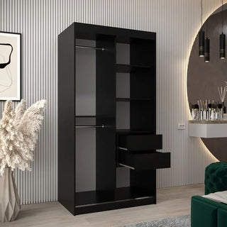 The CHOICEWARDROBE Tavira 2 Door Sliding Mirrored Wardrobe in sleek black features a full-length mirror and internal shelving, making it a modern addition to any bedroom alongside abstract art, a large mirror, and pampas grass decor.