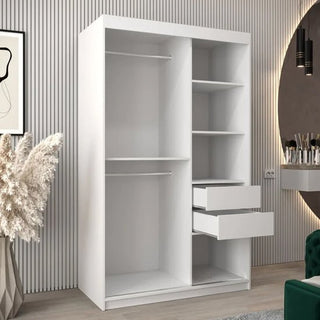 The CHOICEWARDROBE Tavira 2 Door Sliding Mirrored Wardrobe in white features smooth sliding doors, an elegant mirror, and functional shelving—offering stylish bedroom storage in a modern room with wall panels, vanity, and decorative plants.