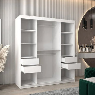 The CHOICEWARDROBE Tavira 2 Door Sliding Wardrobe (180cm, Matt White) features a minimalist modern design with spacious shelving and rails, standing in a contemporary room with striped walls, a round mirror, and decor accents.