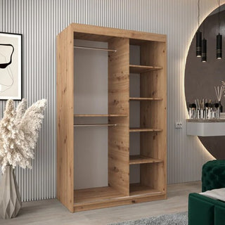 The CHOICEWARDROBE Tavira 2 Door Sliding Wardrobe in Natural Oak features a modern wood grain design with shelves and drawer storage, shown in a stylish room with decorative lighting and a green couch.