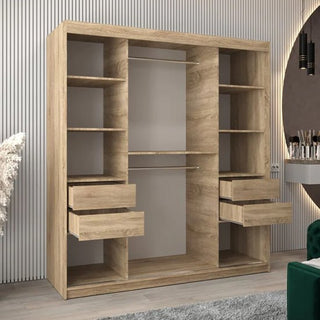The CHOICEWARDROBE Tavira 3 Door Sliding Mirrored Wardrobe in Sonoma Oak Finish features full-length mirror panels, a hanging rail, and organised shelving layout (180cm). Background: vertical white wall panels, round mirror, vanity table.