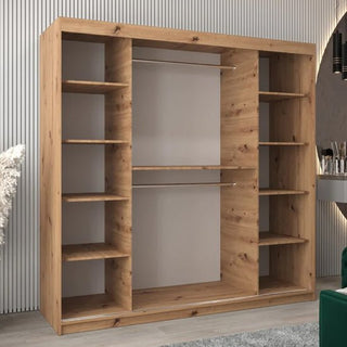 The CHOICEWARDROBE Tavira 3 Mirror Sliding Door Wardrobe, 203cm in Oak Effect Finish, features shelves and a hanging rail, positioned against a light-colored, vertically lined wall in a modern room.