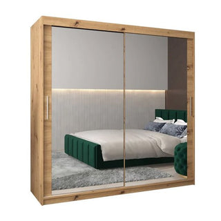 The CHOICEWARDROBE Tavira 3 Mirror Sliding Door Wardrobe in a 203cm oak effect finish offers modern bedroom storage with shelves and a hanging rail, while mirrored doors enhance your room’s style and reflect light.
