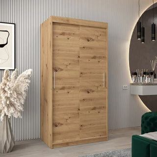 The CHOICEWARDROBE Tavira Oak Wooden Wardrobe features 2 sliding doors, a 100cm compact design with hanging rail, shelves & drawers, in a natural wood finish with silver handles—ideal for stylish, space-saving bedroom storage.