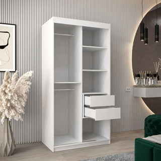 The CHOICEWARDROBE Tavira Wooden Wardrobe in white features 2 sliding doors, internal storage shelves, and a sleek minimalist design, adding modern style and practical storage to any bedroom. Measures 100cm wide for versatile placement.