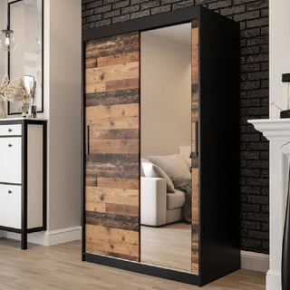 The CHOICEWARDROBE Topeka 120cm Dark Oak & Black 2 Door Sliding Mirrored Wardrobe adds modern industrial style and practical storage to any bedroom, featuring a full-length mirror and rustic wood panel design.
