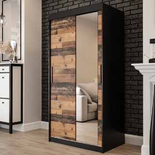 Dark oak sliding wardrobe with mirror doors styled in a modern UK bedroom, combining rustic warmth with contemporary design for compact homes.