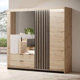 The CHOICEWARDROBE Turin Artisan Oak Sliding Door Wardrobe features three sliding doors—one with a large mirror, LED lighting, and two bottom drawers. Vertical black stripes accent another door for a modern look.