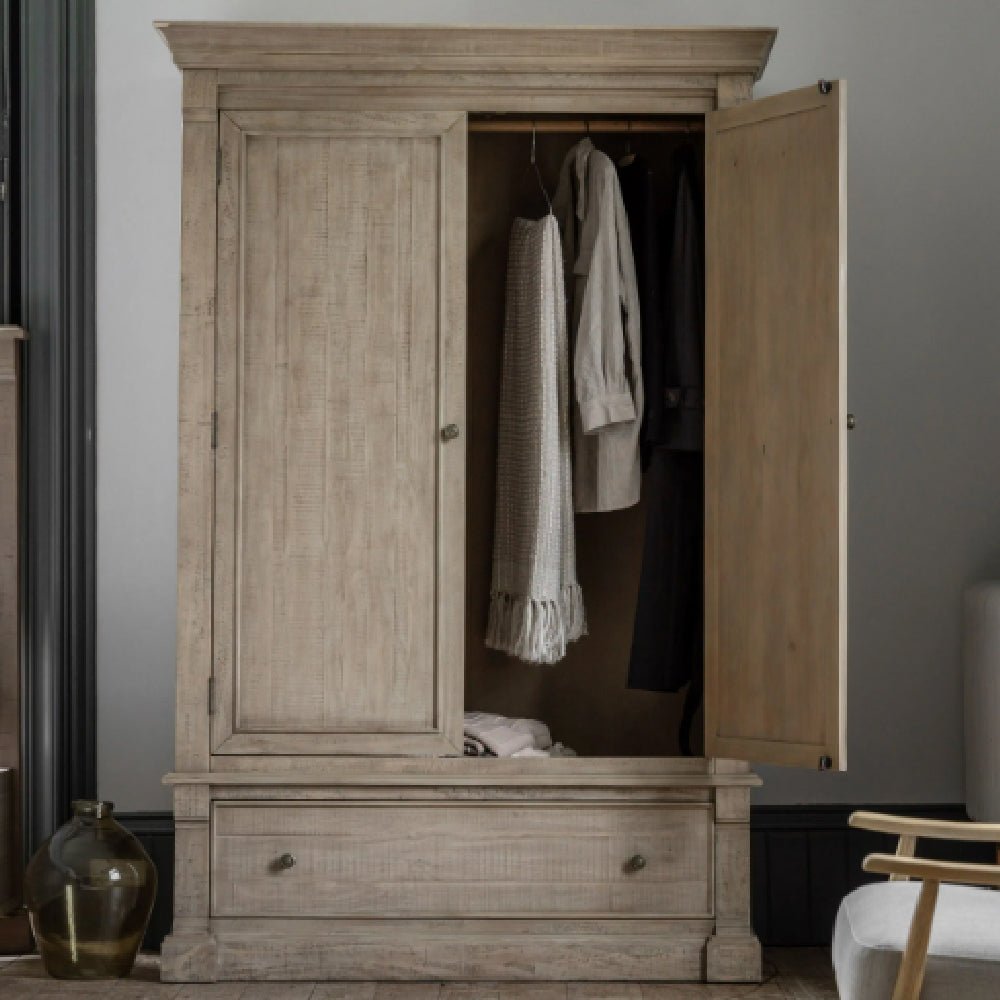 Natural oak wooden wardrobe with 2 paneled doors and 1 drawer. Open door shows hanging clothes.