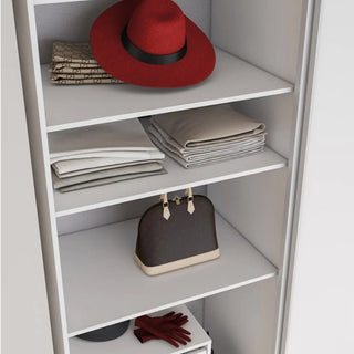 The CHOICEWARDROBE Vesso 3 Door Mirrored Sliding Wardrobe (Matt White, 235cm) features a red hat on the top shelf, beige and white folded clothes in the middle, a dark brown handbag with light trim, and red gloves on the bottom shelf.