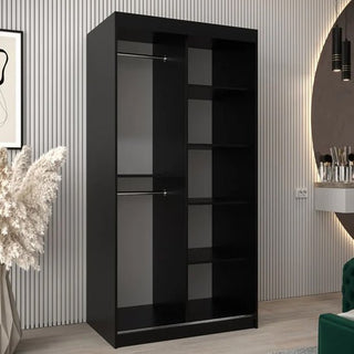 The CHOICEWARDROBE Vevey 2 Door 100cm Sliding Mirrored Wardrobe in black matte offers a compact modern storage solution with stripe panel detail, hanging storage, and open shelves, perfect for rooms with light wood flooring.
