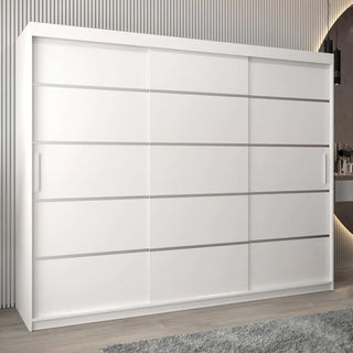 The CHOICEWARDROBE Vevey 3 Door Sliding Wardrobe in 250cm matt white offers deep shelving and premium bedroom storage, shown here on a light wood floor beside a gray rug and vertical wall panels for a sleek modern touch.