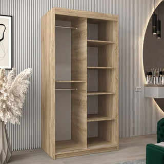 The CHOICEWARDROBE Vevey I 2 Door Sliding Wardrobe in Sonoma Oak offers a modern, space-saving design with shelves and a hanging rail, shown in a stylish room with vertical wall panels, a round mirror, and a green chair.