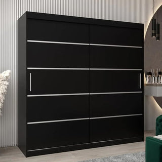 The CHOICEWARDROBE Vevey I Wooden Sliding Door Wardrobe (200cm, black with silver trim) features a modern minimalist design with two sliding doors and sleek handles, standing out beautifully against vertically paneled walls.