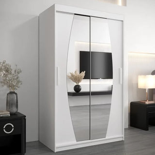 The Eden Mirrored Wardrobe 2 Sliding Doors 120cm in White stands in a modern room with a black nightstand and vase of dried flowers on the left, a lamp on another black cabinet to the right, and a TV mounted on the wall behind.