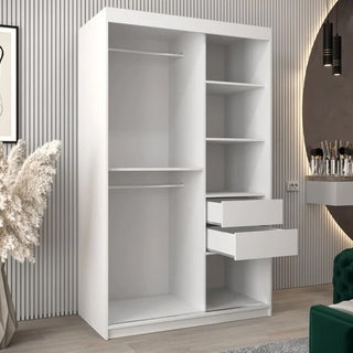 The Eden Mirrored Wardrobe with 2 sliding doors (120cm, white) is a stylish addition to any modern bedroom, pairing its sleek design with a decorative wall, vanity, mirror, and a vase with pampas grass.