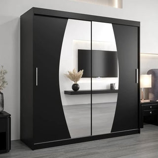 The room features the Eden Mirrored Wardrobe 2 Sliding Doors 200cm in Black with a large oval mirror, alongside a wall-mounted TV, a floating shelf with a vase, and part of a bed visible on the right.