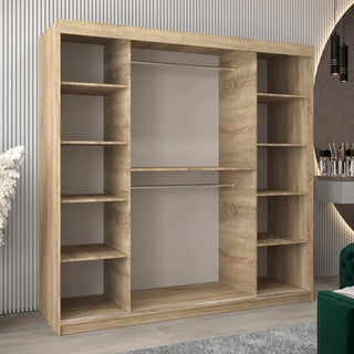 The Eden Mirrored Wardrobe with 2 sliding doors in Sonoma Oak (200cm) features spacious shelving and hanging space, perfectly complementing a modern room with light-colored striped walls.