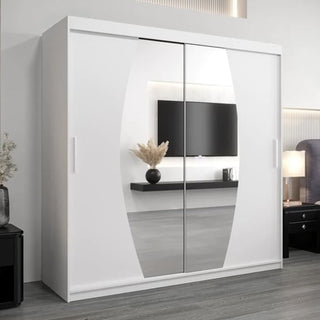 The Eden Mirrored Wardrobe 2 Sliding Doors 200cm In White reflects a wall-mounted TV, floating shelf with vase, and part of a bed in a contemporary bedroom with grey flooring.