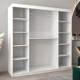 A modern room features the Eden Mirrored Wardrobe 2 Sliding Doors 200cm in White, offering stylish storage with spacious open shelves and two central hanging rods, set against a backdrop of vertical striped walls.