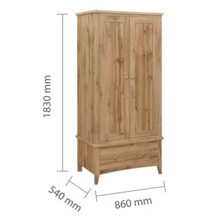 The Hebron Wooden Wardrobe With 2 Doors 1 Drawer In Oak features simple metal handles, a bottom drawer, and a natural wood finish. It measures 1830mm high, 860mm wide, and 540mm deep for classic bedroom storage.