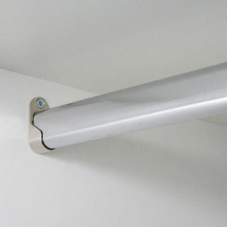The Inverto Additional Hanging Rail, a 250cm aluminium rail for sliding wardrobes, is mounted near the ceiling on a white wall with a beige bracket and two screws—perfect for extra storage.