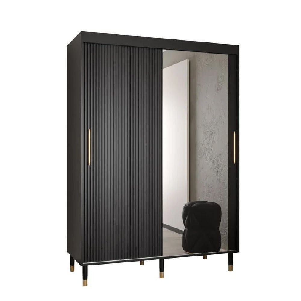 Black wardrobe with ribbed door, mirrored sliding door, and gold handle on raised legs.