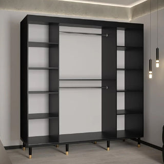 The Millwall 200cm Mirrored Wardrobe with 2 Sliding Doors in Black features open shelving on both sides, two central metal hanging rods, and gold-capped feet, perfect for minimalist rooms with pendant lights and light wood floors.