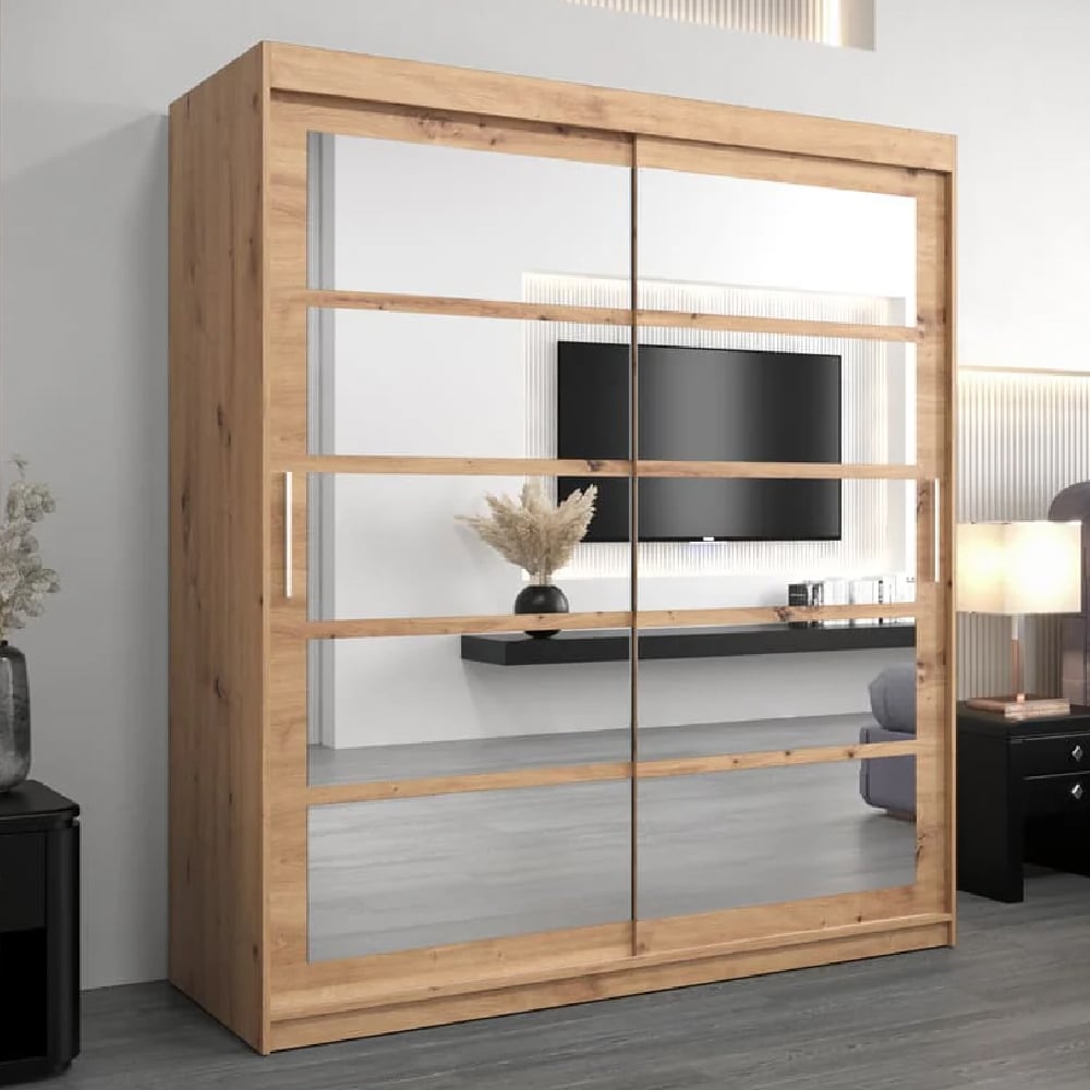 Oak Artisan sliding door wardrobe with mirrored doors reflecting a TV and shelf