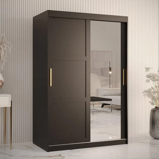 The Rieti II Mirrored Wardrobe with 2 black sliding doors (120cm) features vertical gold handles and a large mirrored panel, showcased in a minimalistic room with light walls and marble flooring.