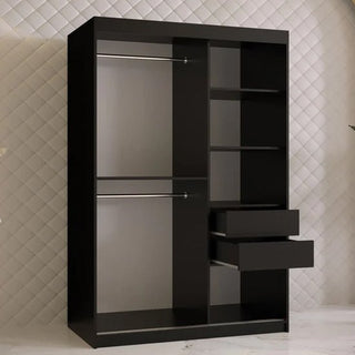 The Rieti II Mirrored Wardrobe 2 Sliding Doors 120cm in Black stands against a quilted-pattern wall and white floor, featuring two left hanging rods, four right shelves, and two open drawers beneath the shelves.