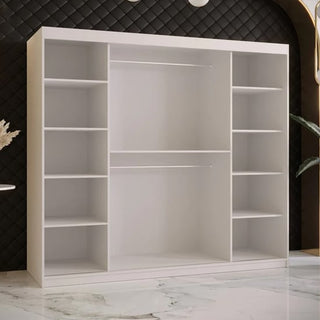 The Rieti II Mirrored Wardrobe with 2 sliding doors in white (200cm) features multiple shelves on both sides and in the center, plus two hanging rods. It’s shown against a black quilted wall with marble flooring.