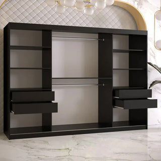 The Rieti II Mirrored Wardrobe with 2 sliding doors (250cm, black) features two hanging rods, shelves, and four drawers. It stands against a white wall with a quilted design and gold accents on a white floor with light gray veining.