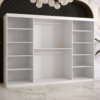 The Rieti II Mirrored Wardrobe with 2 sliding doors in white (250cm) stands against a black, quilted wall. The room features a white marble floor with gray veining and is illuminated by a modern chandelier above.
