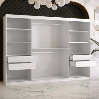 The Rieti II Mirrored Wardrobe with 2 sliding doors in white (250cm) features open shelves, two hanging rods, and four drawers. It stands against a black quilted wall with a gold-arched border and marble floor beneath a modern chandelier.