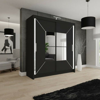 A modern bedroom with the BARTHOLOMEW 2 Door Mirrored Wardrobe Black 203cm, high gloss sliding doors, geometric white accents, minimalist furniture, black pendant lights, and a framed monochrome artwork on the wall.