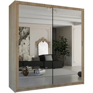 The CHICAGO II 2 Door Mirrored Wardrobe in Oak (203cm) combines modern style and practical bedroom storage, reflecting decor like a black sofa, marble coffee table, decorative mirror, and potted plant.