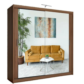 The Sliding Wardrobe - CHICAGO II 2 Door Mirrored Wardrobe Walnut - 203 adds style and storage, reflecting a room with a mustard yellow sofa, small white table with plant, and abstract painting on a white wall.