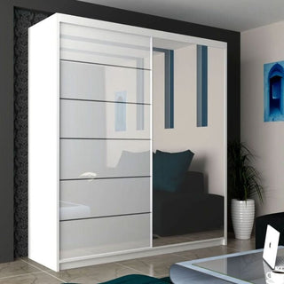 The CHOICEWARDROBE Infinite 2 Door Sliding Mirrored Wardrobe, 150cm wide in a modern white finish, stands against a dark wall, reflecting a black sofa, blue cushions, wall art, a potted plant, and part of a glass table.