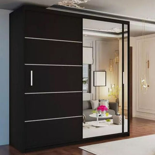 The sleek KEYNES 2 Door Mirrored Wardrobe in black (203cm) adds a modern touch to a minimalistic room with large windows and a cozy seating area.
