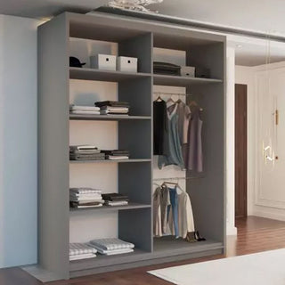 The KEYNES 2 Door Mirrored Wardrobe in grey (150cm) stands against a white wall in a well-lit room with hardwood floors, offering spacious storage with shelves for folded clothes, space for storage boxes, and hanging rods for garments.