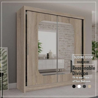 The MERICA 2 Door Mirrored Wardrobe Oak (180cm) stands against a light wall. Its large central mirror reflects decorative plants and shelves, emphasizing the bedroom's spacious storage features. Text highlights its modern design.
