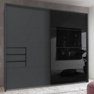 The SOGO 2 Door Wardrobe Graphite with Black 225cm features ample bedroom storage, including three left-side drawers and a black reflective panel on the right, complementing light floors and neutral walls.
