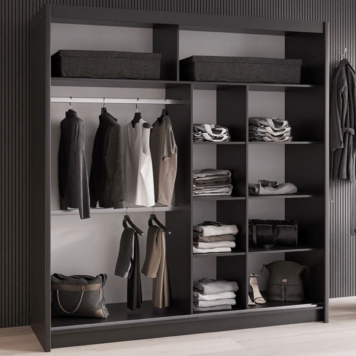 Black sliding wardrobe interior with hanging clothes and organised shelves